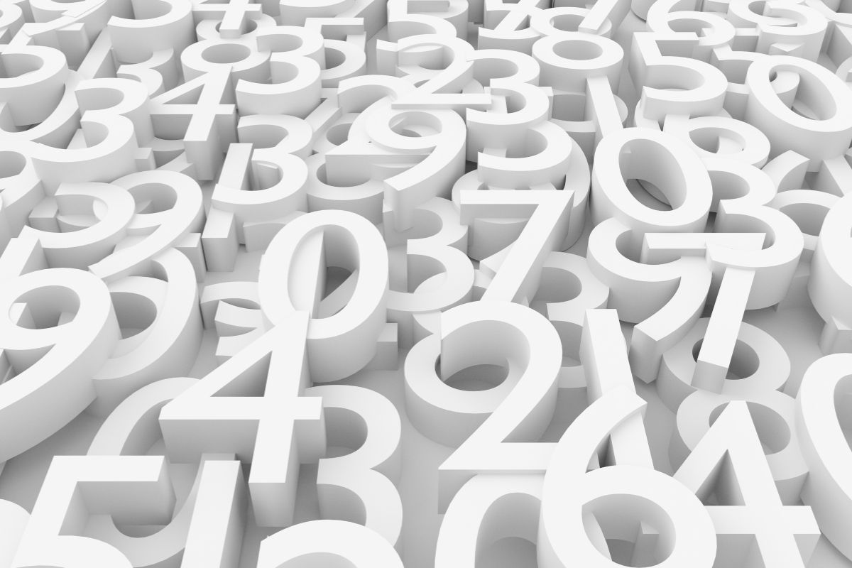 The image shows a dense arrangement of large, three-dimensional white numbers layered closely together, filling the entire frame. Digits from zero through nine overlap and stack at different angles, creating a sense of depth and repetition. The numbers appear smooth and matte, with soft shadows falling between them, suggesting a studio-lit environment. There is no visible background, as the numbers extend edge to edge, giving the impression of abundance and complexity. The uniform white color removes distraction from individual digits, encouraging focus on the overall pattern rather than specific values. The image visually represents quantity, counting, and numerical concepts, evoking ideas of mathematics, data, or early learning. The lack of color contrast emphasizes form, shape, and structure, making the scene feel modern, abstract, and slightly overwhelming, much like encountering numbers in bulk rather than in sequence.